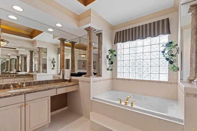a spacious bathroom with a granite countertop tub sink and mirror