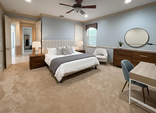 a bedroom with bed and a chandelier