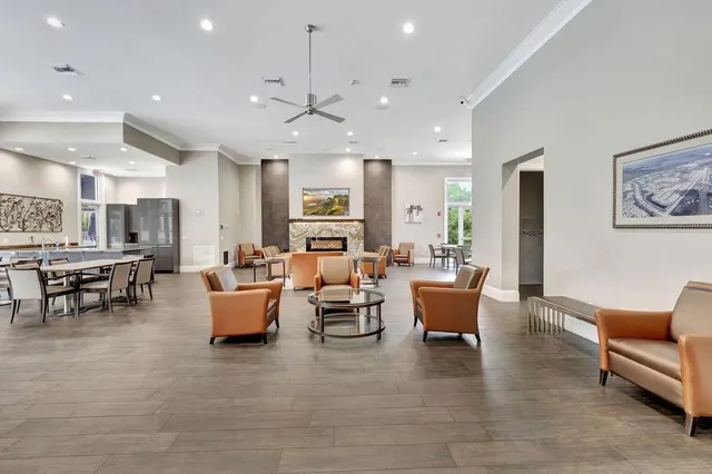 a living room with furniture and a dining table with kitchen view