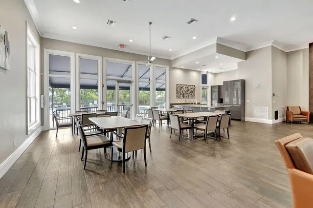 a dining room with furniture and wooden floor