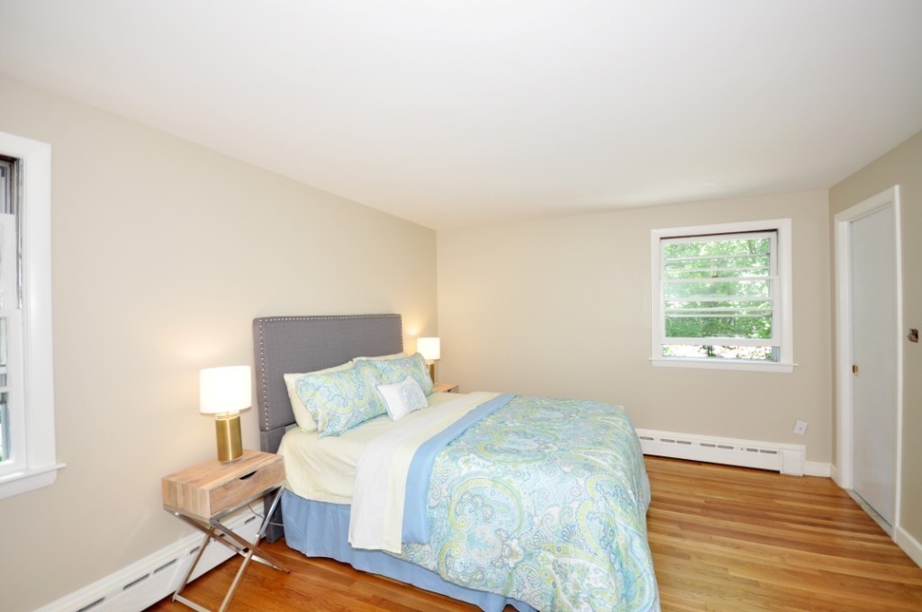 23 Peachtree Road Lexington, MA 02420 - Photo 16 of 30 a bedroom with a bed and wooden floor