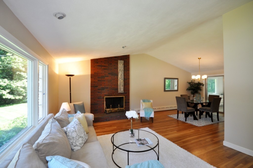 23 Peachtree Road Lexington, MA 02420 - Photo 5 of 30 a living room with furniture dining table and a fireplace