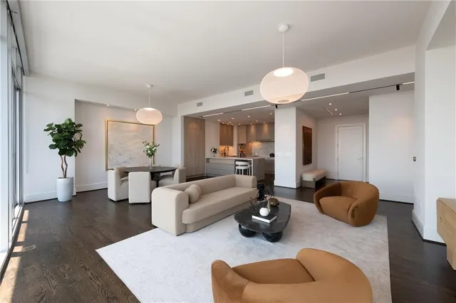 a living room with furniture potted plant and a chandelier