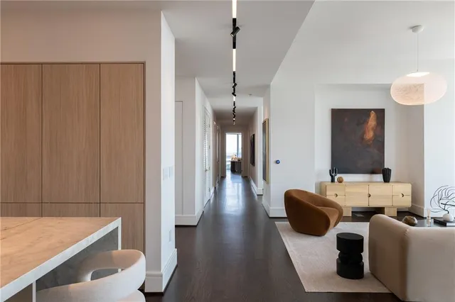 a living room with furniture and a floor to ceiling window
