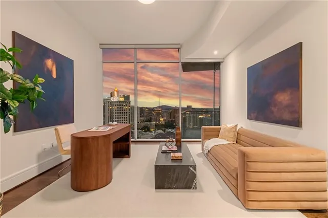 a balcony with view of couch and wooden floor