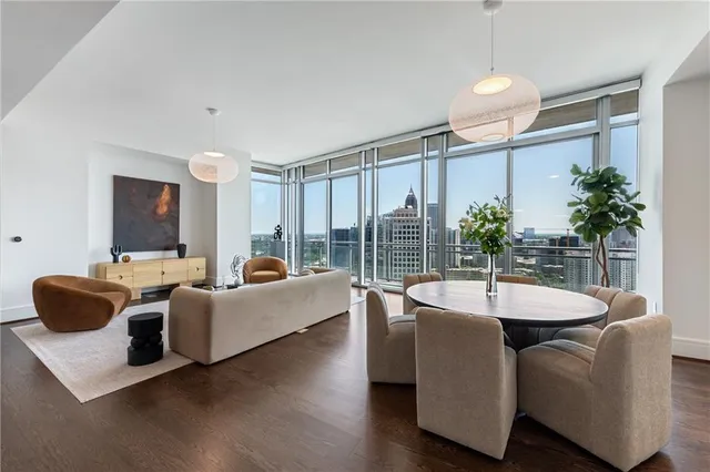a dining room with furniture and potted plants