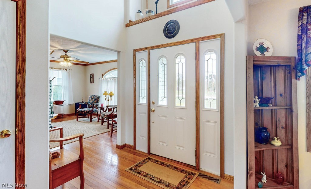 10147 Page Road Streetsboro, OH 44241 - Photo 2 of 35 Foyer entrance with light hardwood / wood-style flooring, ceiling fan, and crown molding
