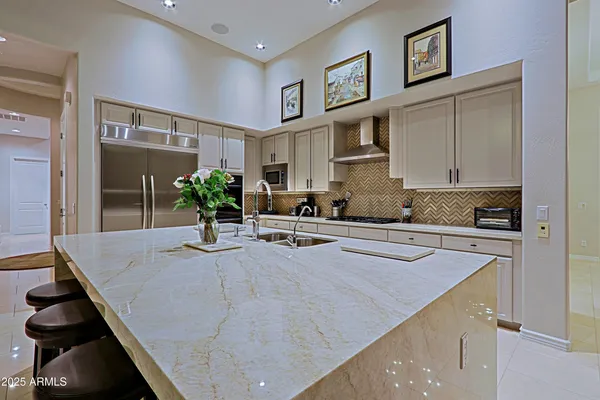 a living room with furniture a flat screen tv and floor to ceiling window