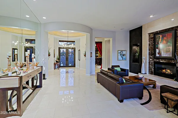 a view of living room kitchen with stainless steel appliances granite countertop a large window and a sink