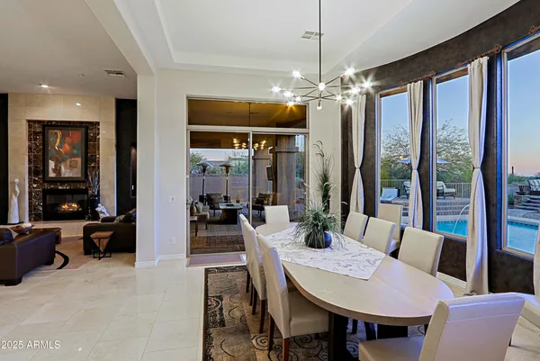 a bedroom with a bed a couch and a chandelier