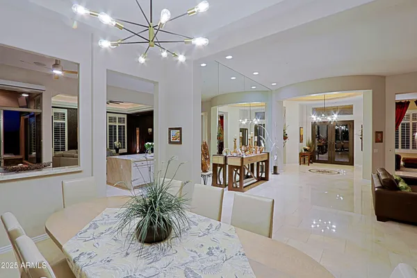 a living room with furniture a ceiling fan and a window