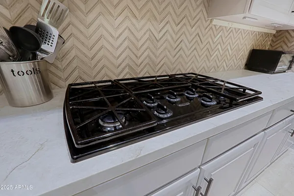 a bathroom with a granite countertop sink a toilet a mirror and shower