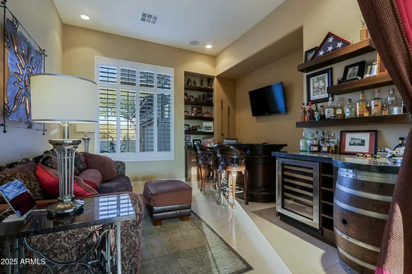 a view of a patio with a table and chairs under an umbrella with a small yard