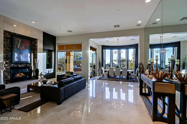 a living room with furniture fireplace and a large window