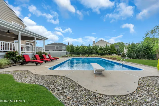 a view of a swimming pool with lounge chairs