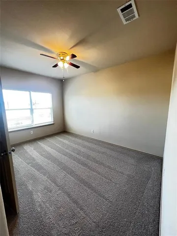 a view of a livingroom with a ceiling fan and window