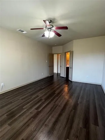 a view of an empty room and wooden floor