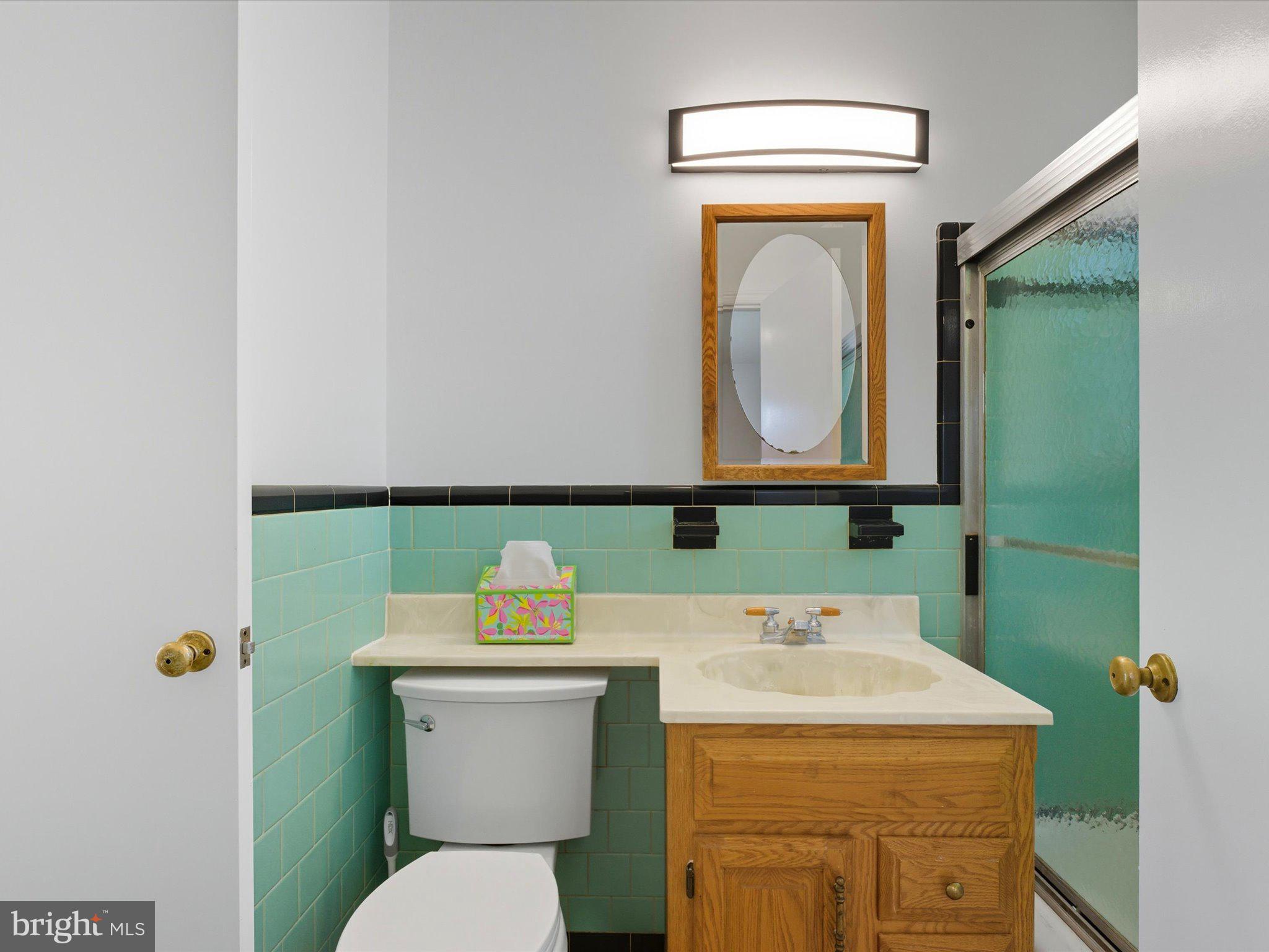 12907 Matey Road Silver Spring, MD 20906 - Photo 19 of 45 a bathroom with a sink a toilet and mirror