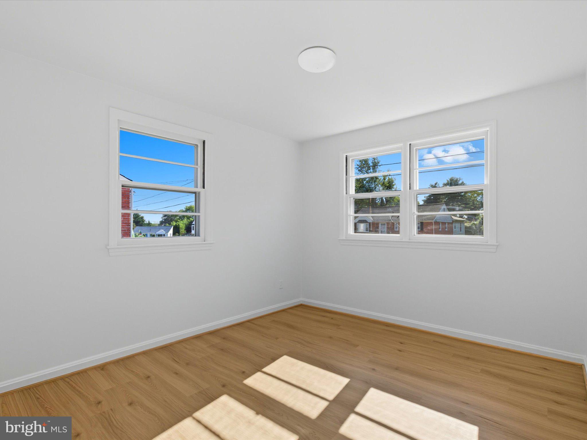 12907 Matey Road Silver Spring, MD 20906 - Photo 22 of 45 a view of an empty room with wooden floor and a window
