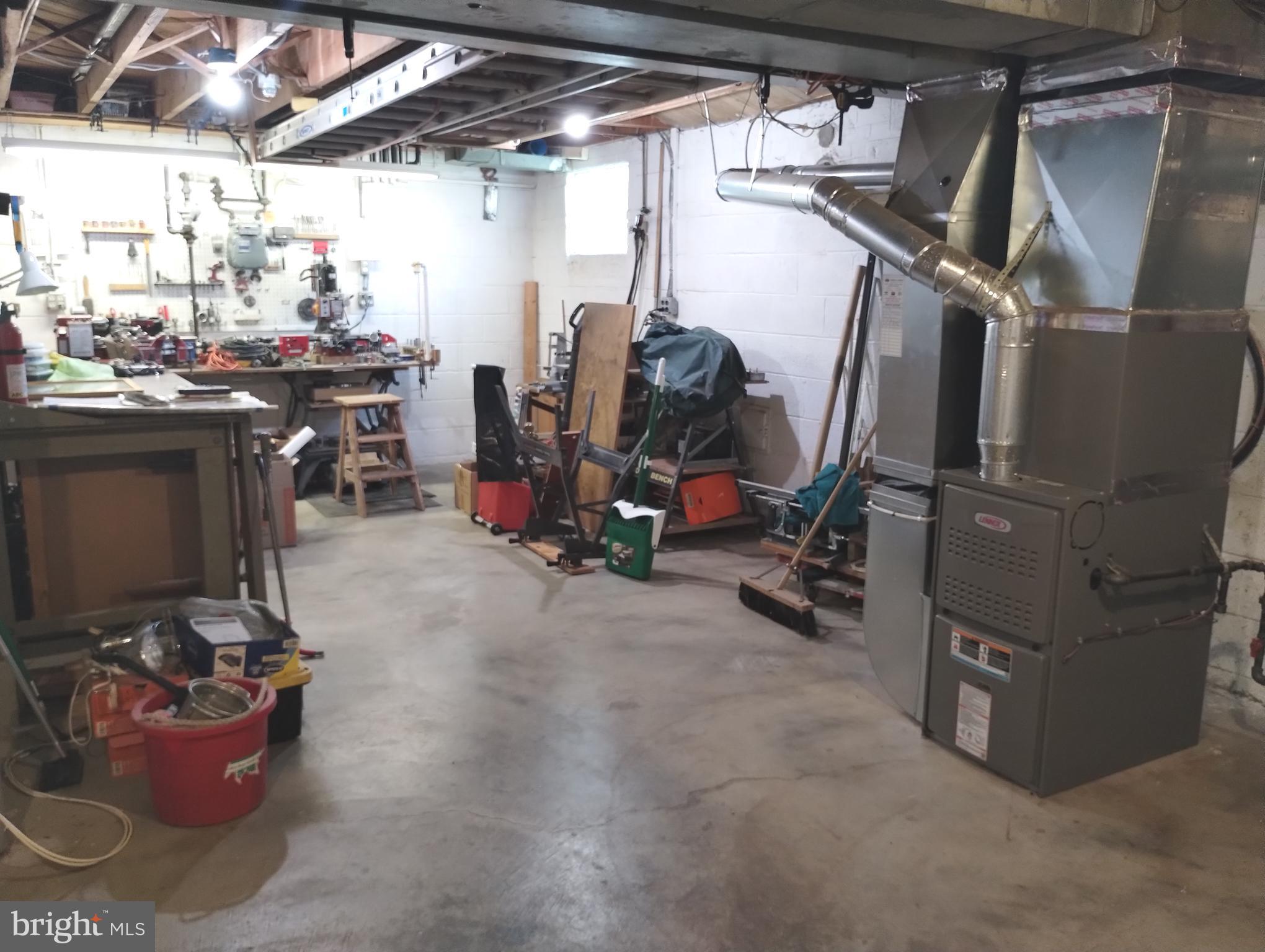 12907 Matey Road Silver Spring, MD 20906 - Photo 39 of 45 a view of a storage room with water heater and racks