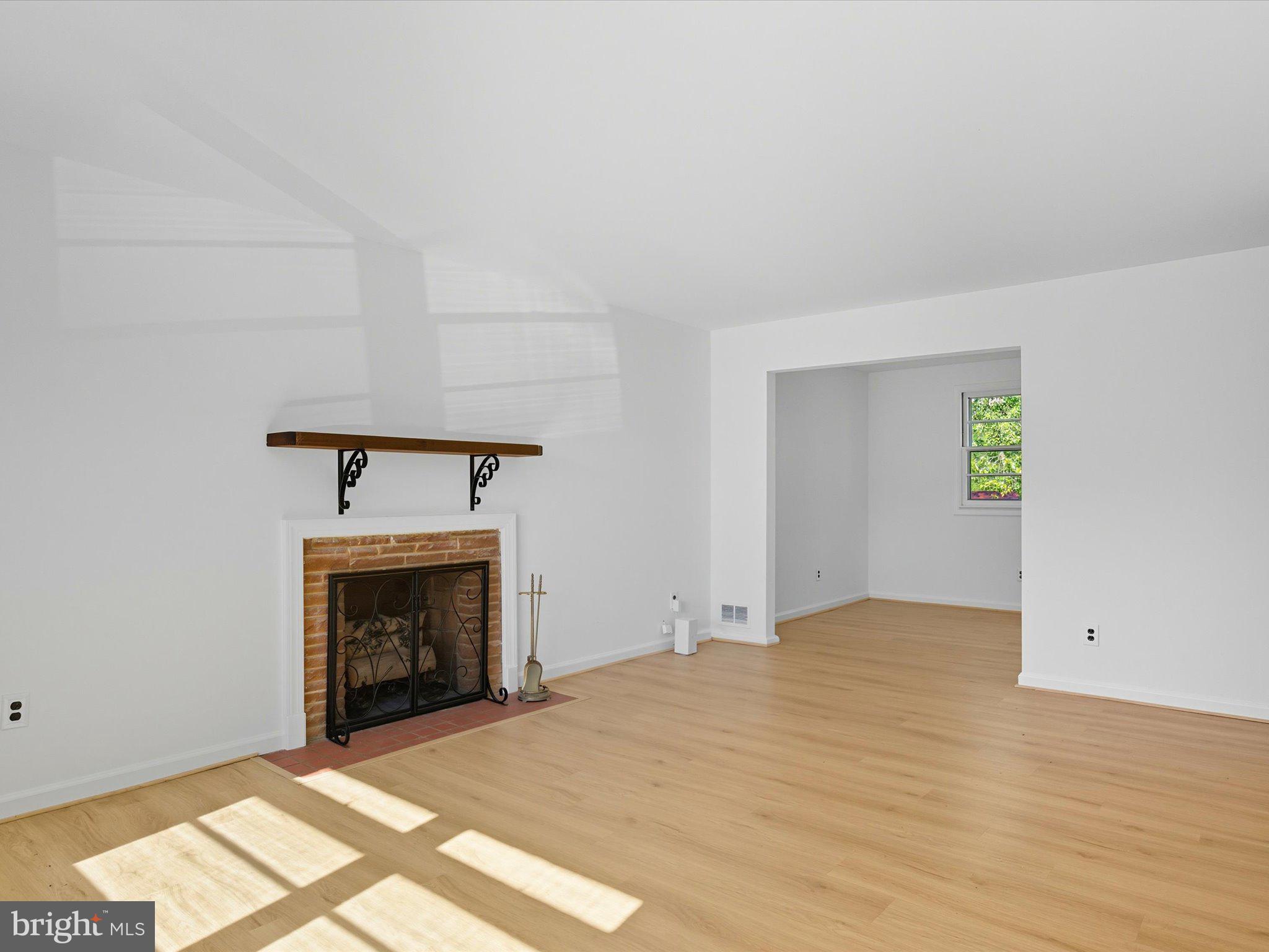 12907 Matey Road Silver Spring, MD 20906 - Photo 5 of 45 a view of an empty room with a fireplace