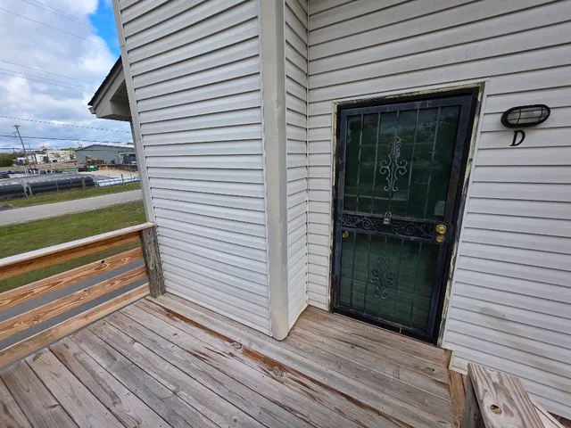 a view of a balcony with a door and wooden floor