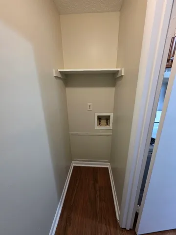 a hallway with a washer and dryer