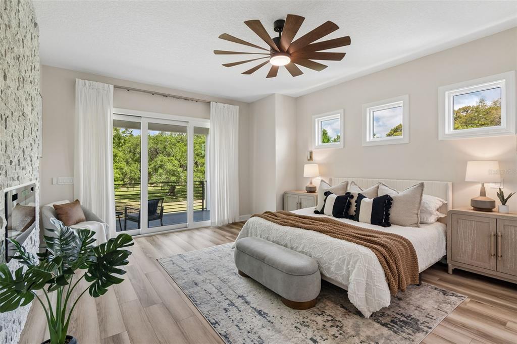 13711 Lussier Lane Spring Hill, FL 34610 - Photo 16 of 88 a spacious bedroom with a large bed a potted plant and a window