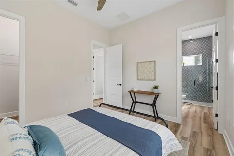 a view of a hallway with furniture and wooden floor
