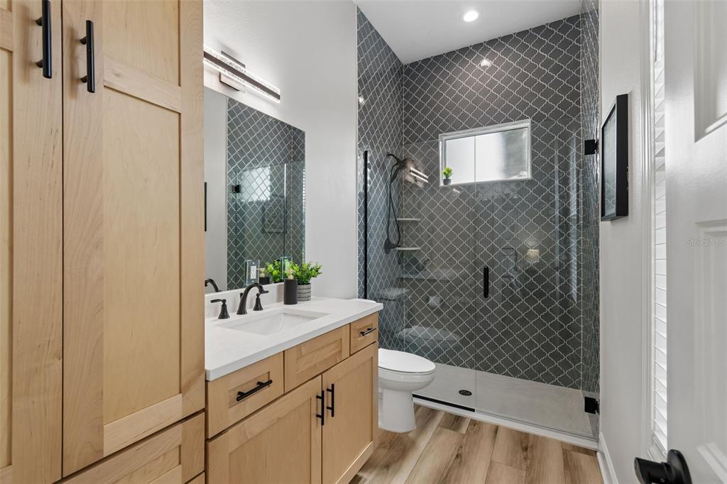 13711 Lussier Lane Spring Hill, FL 34610 - Photo 22 of 88 a bathroom with a sink a toilet and shower