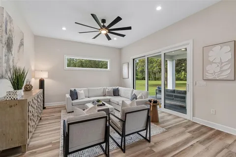 a view of a dining room with furniture large windows and wooden floor