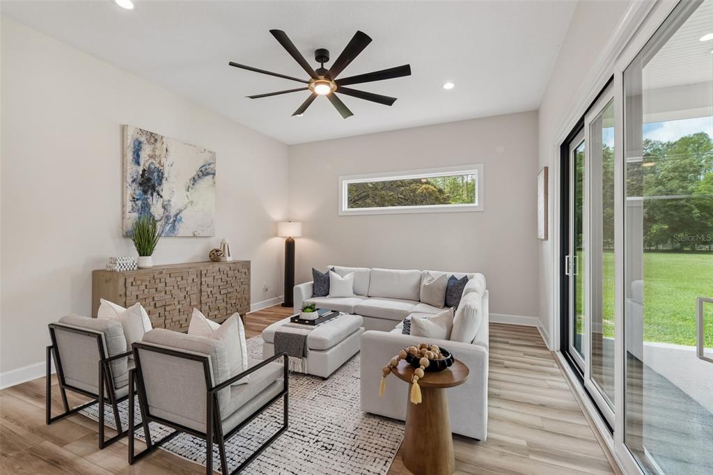 13711 Lussier Lane Spring Hill, FL 34610 - Photo 37 of 88 a living room with furniture and a wooden floor