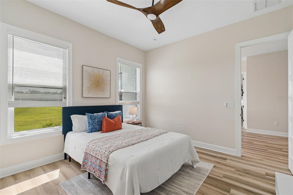 13711 Lussier Lane Spring Hill, FL 34610 - Photo 52 of 88 a bedroom with a bed and wooden floor