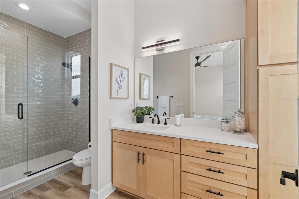 13711 Lussier Lane Spring Hill, FL 34610 - Photo 53 of 88 a bathroom with a shower sink and mirror