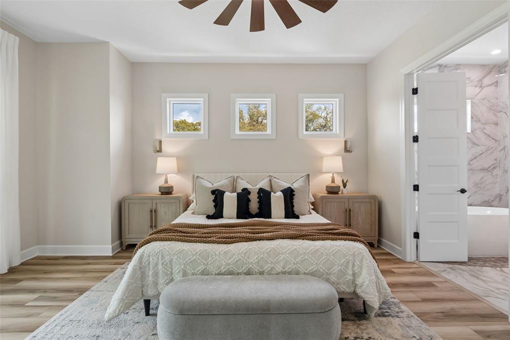 13711 Lussier Lane Spring Hill, FL 34610 - Photo 55 of 88 a bed room with a bed and a chandelier