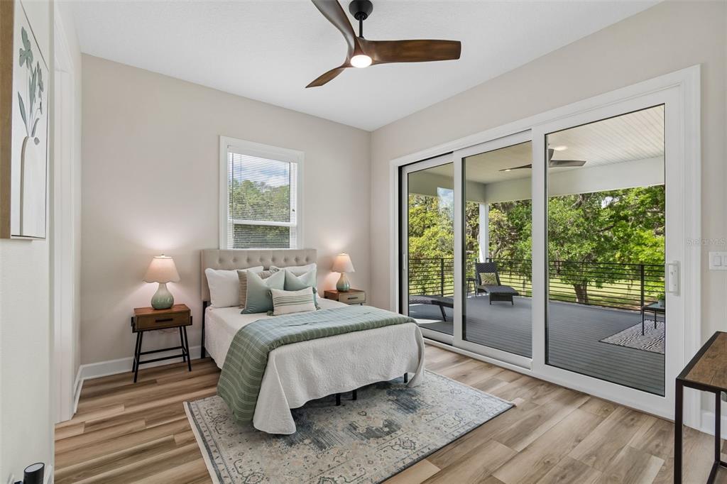 13711 Lussier Lane Spring Hill, FL 34610 - Photo 63 of 88 a bedroom with a bed and a night stand