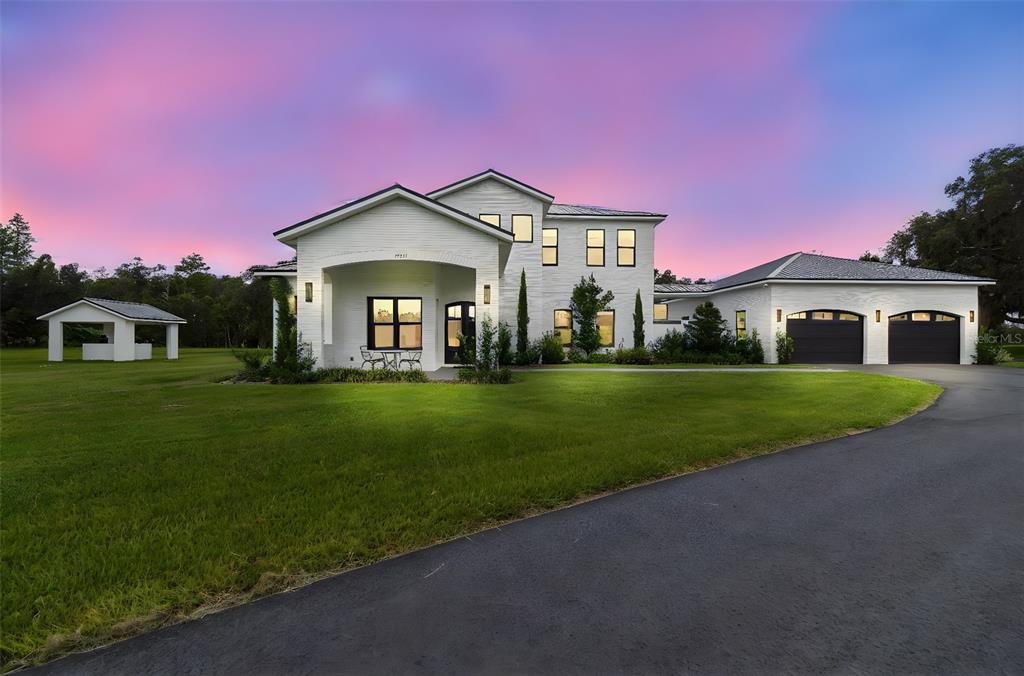 13711 Lussier Lane Spring Hill, FL 34610 - Photo 78 of 88 a front view of a house with a garden and yard