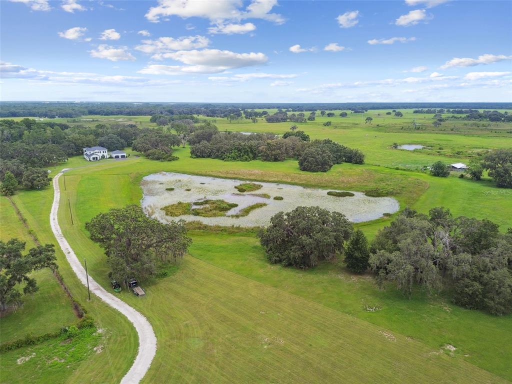 13711 Lussier Lane Spring Hill, FL 34610 - Photo 85 of 88 a view of a lake with a big yard