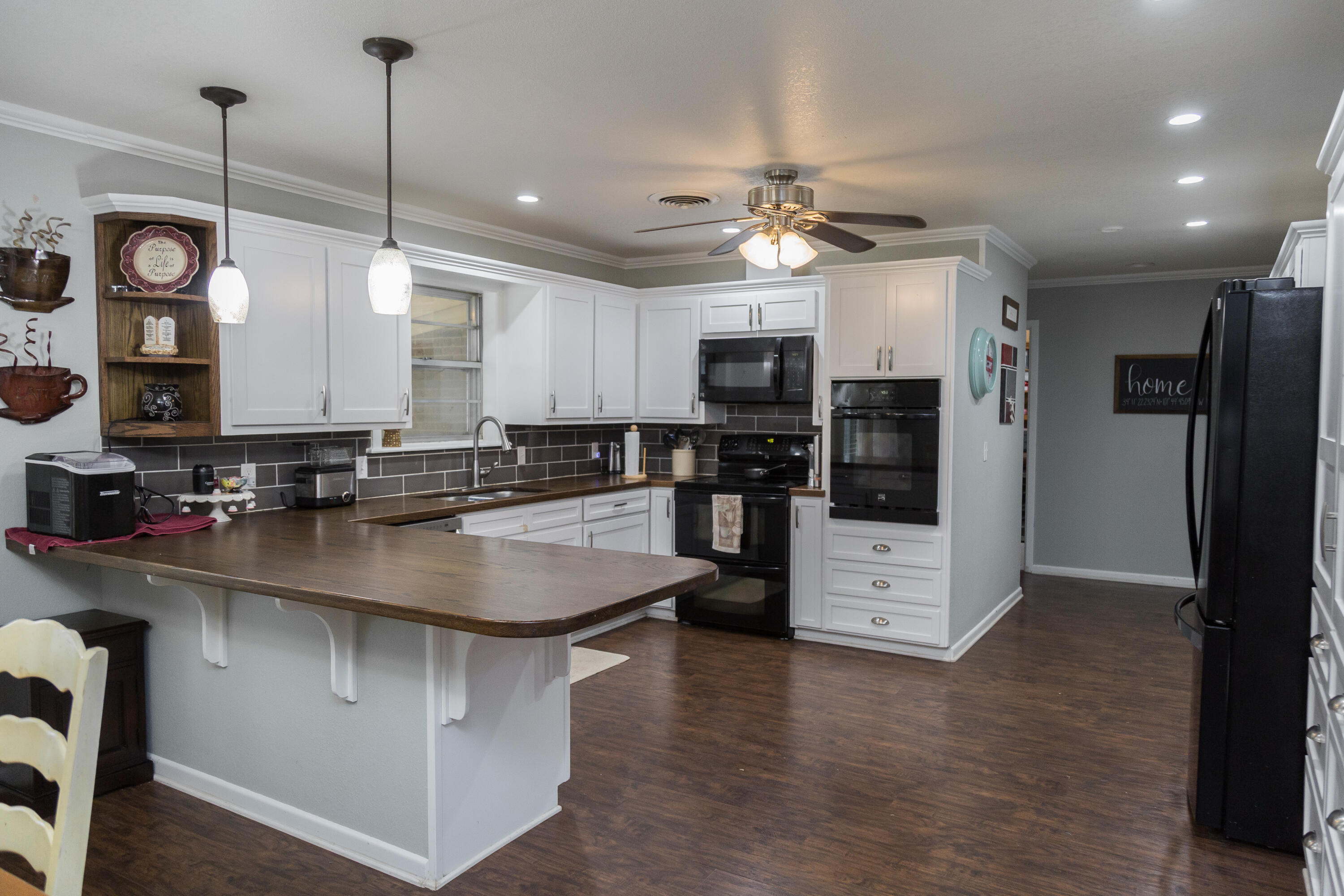 904 Itasca Street Plainview, TX 79072 - Photo 12 of 53 a kitchen with stainless steel appliances granite countertop a sink a stove and a refrigerator