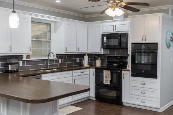 a kitchen with stainless steel appliances granite countertop a stove and a sink