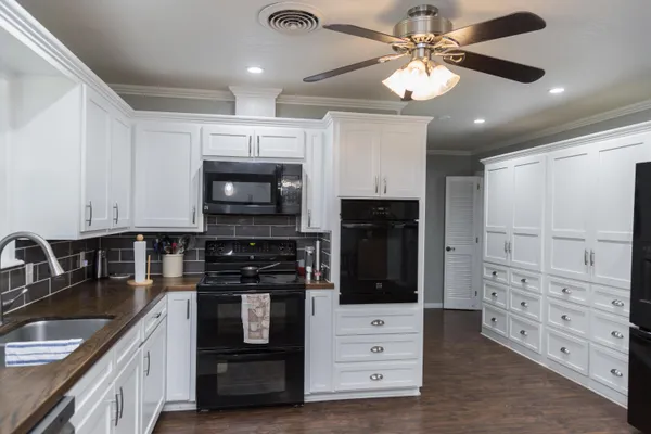 a kitchen with stainless steel appliances granite countertop a stove and a sink
