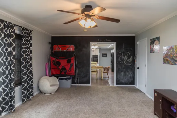 a room with a dresser and a window