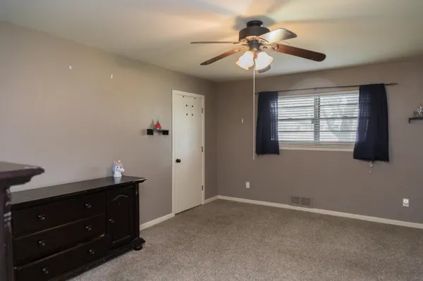 a bedroom with furniture and a window
