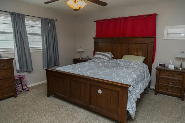 a bedroom with a bed and a chandelier