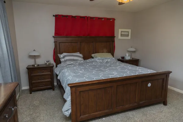 a bedroom with a bed and a dresser