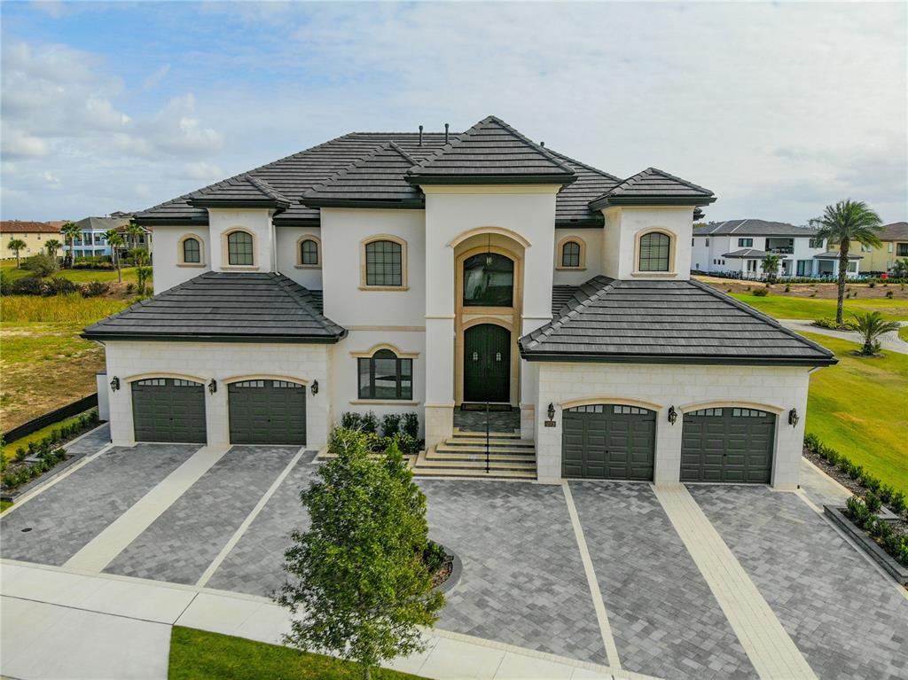 8033 Twin Eagles Loop Reunion, FL 34747 - Photo 11 of 42 a front view of a house with garden