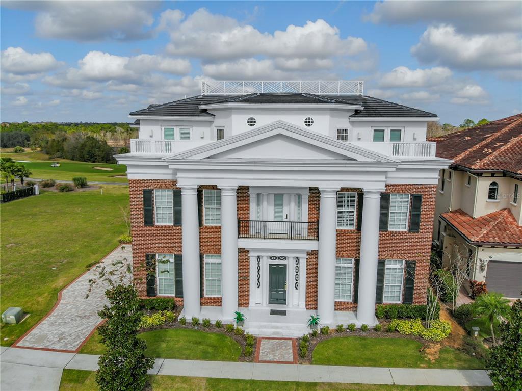 8033 Twin Eagles Loop Reunion, FL 34747 - Photo 12 of 42 a front view of a house with garden