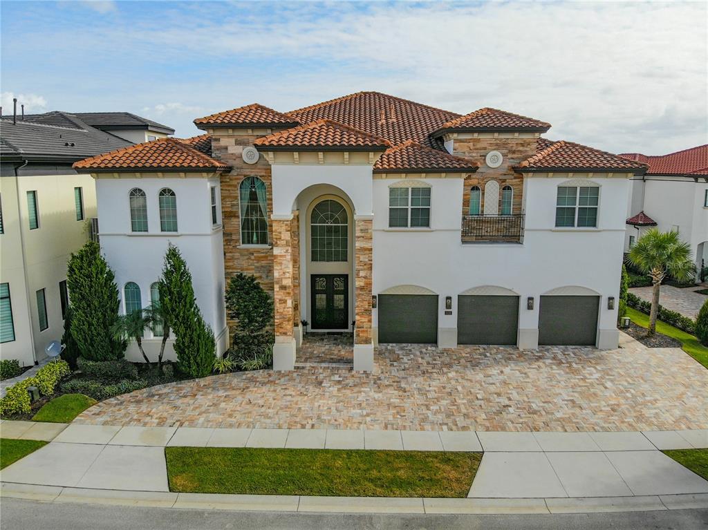 8033 Twin Eagles Loop Reunion, FL 34747 - Photo 15 of 42 a front view of a house with garden