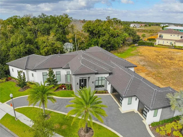 an aerial view of residential houses with outdoor space and seating area