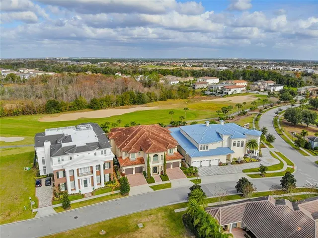 an aerial view of residential houses with outdoor space and lake view